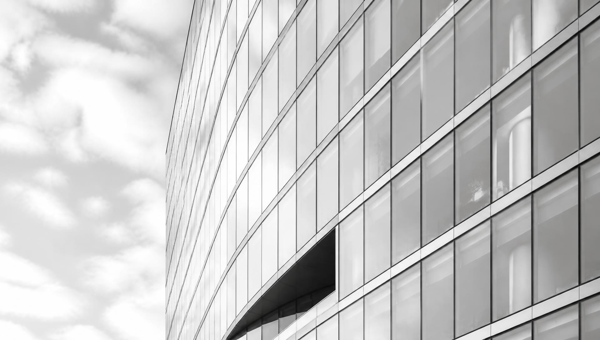 Bright modern glass office tower facade in black and white